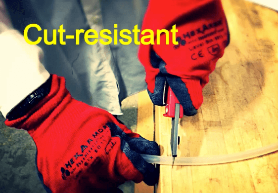 Cut-resistant red gloves demonstrate durability with box cutter