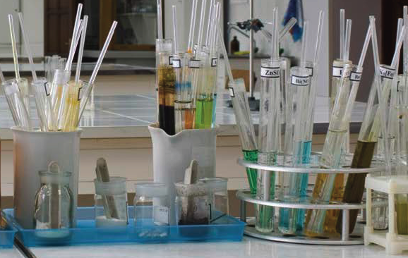 Collection of laboratory test tube and pipettes in containers