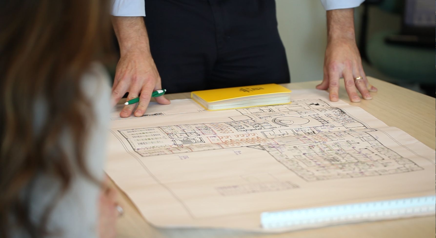 Blueprint of facility being examined on a table