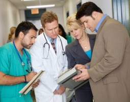 Financial manager reviews data with doctor, nurse and department head