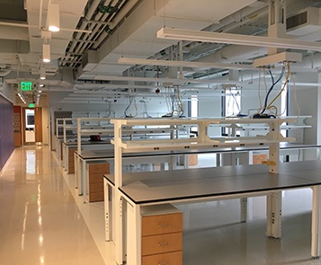 Empty laboratory with white tables and floor