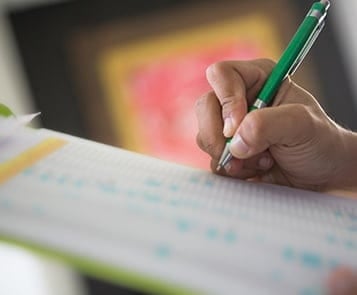 Worker completes EHS audit paperwork on clipboard