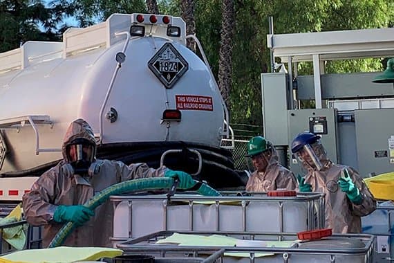 EHS tank workers working with truck
