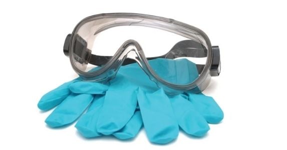 PPE with an eye mask and rubber gloves