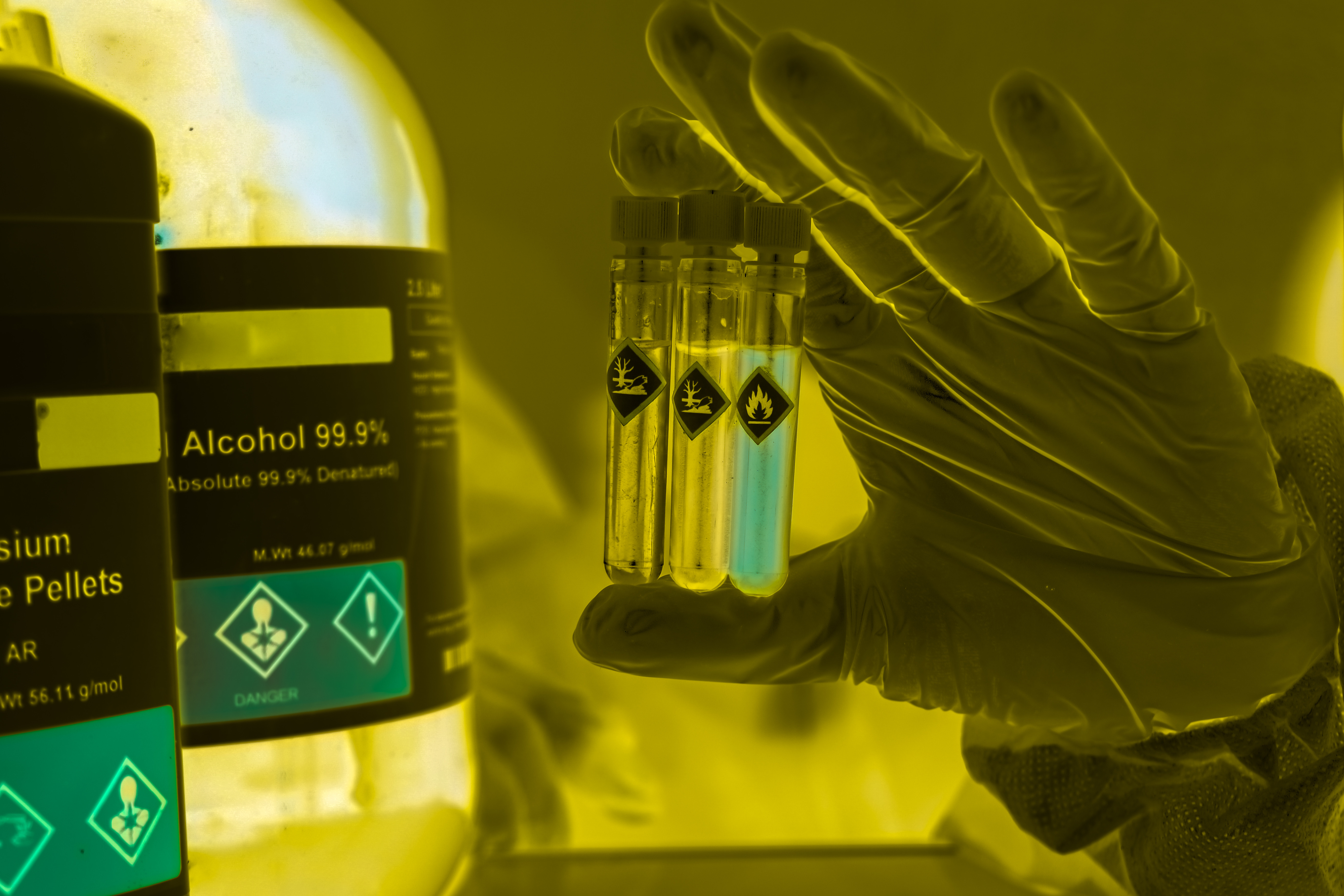 Gloved Hand Holding Test Tubes