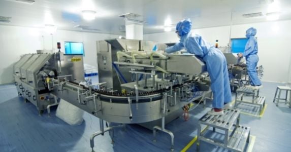 pharmaceutical workers operating machinery