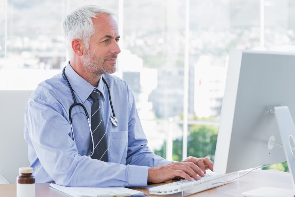 Doctor reviewing hazardous drug info on computer