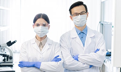 Two EHS workers in gloves and face masks