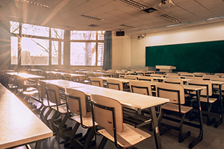 Higher education empty classroom with wooden chairs