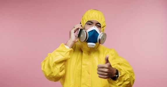 worker wearing respirator and protective suit