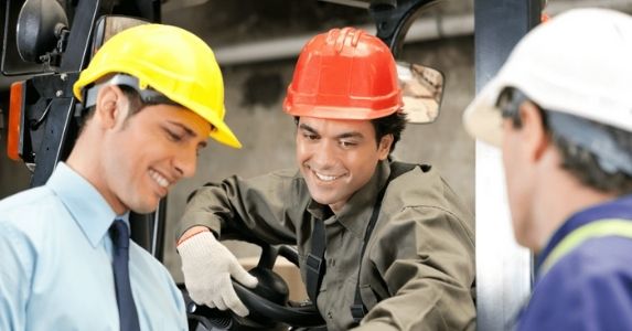 workers wearing hardhats discussing plans