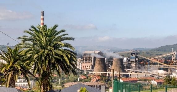 large facility with palm tree in foreground