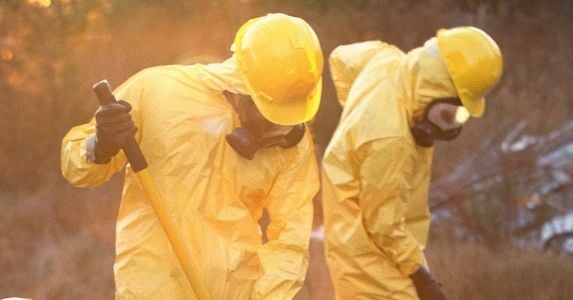 workers with shovels wearing full ppe protection