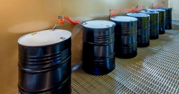 hazardous waste drums secured to wall