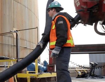 EHS worker in safety vest managing oil spill