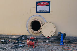 An OSHA compliant confined entry space with equipment outside for training purposes