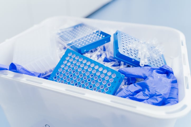 gloves and pipette tip boxes in waste