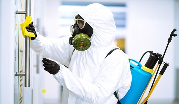 Lab employee wearing protective gear works to reduce COVID-19 